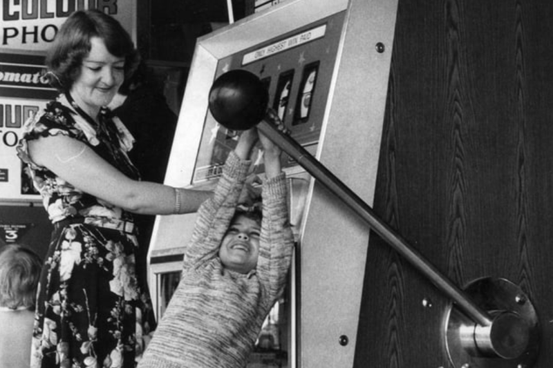 Lorraine Cardno, 7 having a go on the giant one armed bandit in South Shields fairground in 1977 with mum Sandra watching. Photo: gz