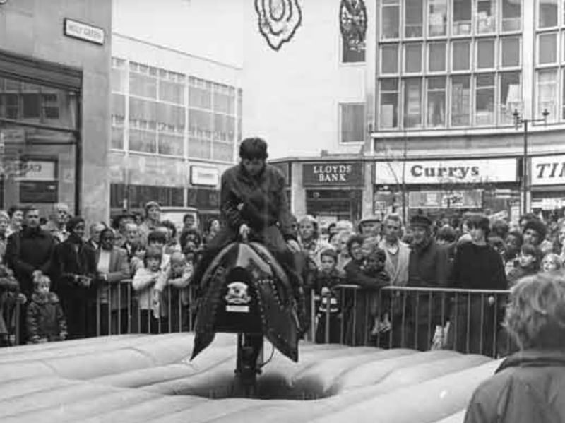 A fairground attraction on Holy Green, just off The Moor, Sheffield city centre, in 1981, with Lloyds Bank and Currys electrical retailer in the background. Photo: Picture Sheffield