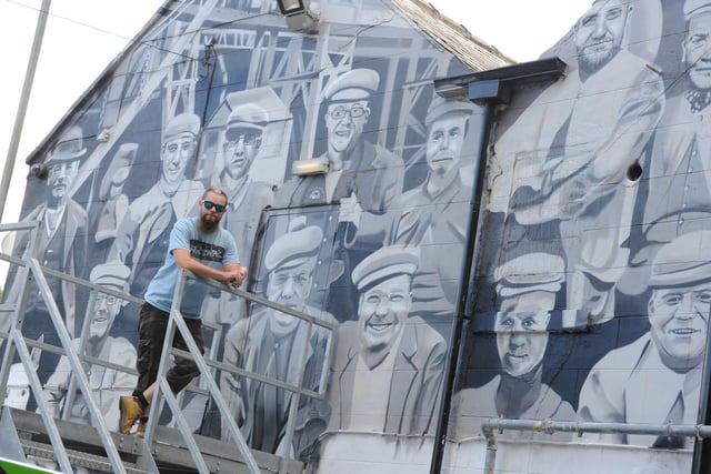 Mural artist Frank Styles with his latest work at the Shipwrights Hotel, in 2015.