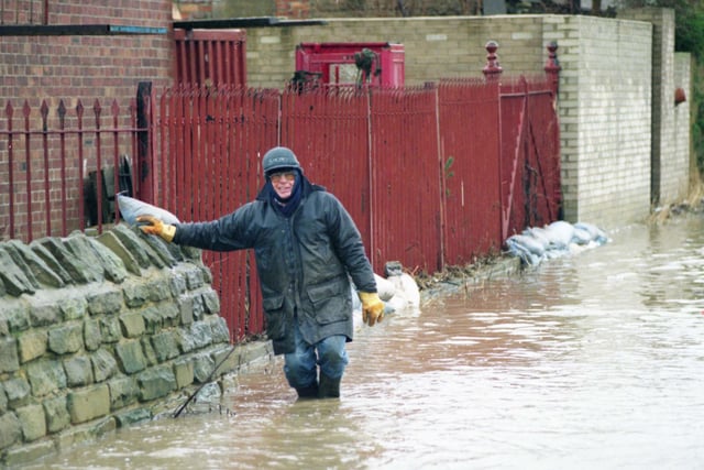 Stephen Smith helps protect the Moorings Boat Club in Ferryboat Lane, from the floods of 1996.