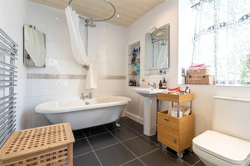 The main bathroom which includes a free-standing bath and is spacious in size. 