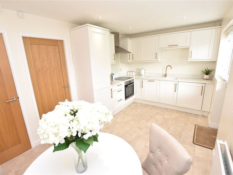 The modern dining kitchen combination with a range of wall and base units.