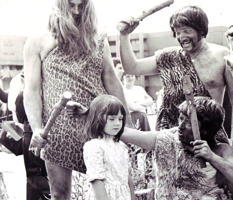 Little six year old Claire Kingham doesn't look in the least bit amused by the strange sight of these 'cavemen' who led off the Sheffield Historical Pageant on July 10, 1976