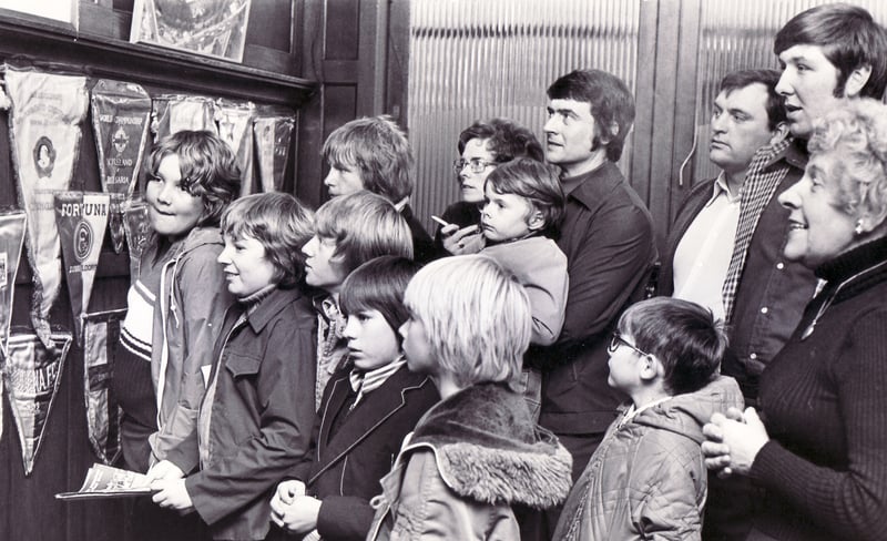Visitors to Sheffield Wednesday's Hillsborough stadium take a look at some of the pennants on display in the trophy room in this scene from October 1976