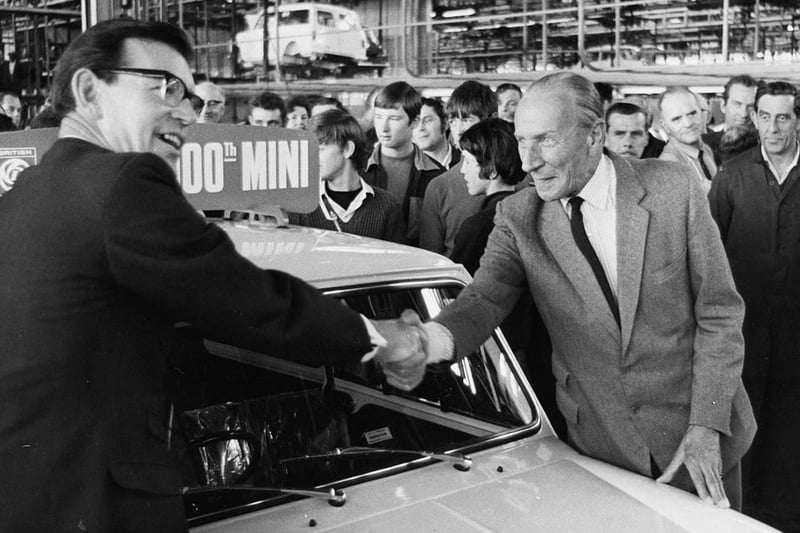 George Turnbull (left), Managing Director of the Austin Morris and British Leyland, shaking hands with Alec Issigonis, designer of the Mini, celebrating as the two millionth Mini car rolls off the production line at the Longbridge factory, June 19th 1969. (Photo by Keystone/Hulton Archive/Getty Images)