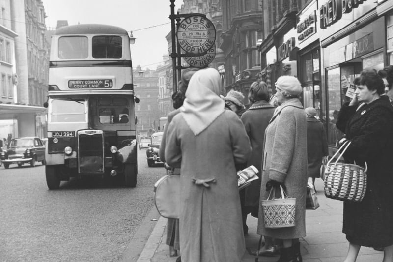 February 1962:  Women waiting in a bus queue outside a shop in Corporation Street, Birmingham.  (Photo by Marshall/Fox Photos/Getty Images)