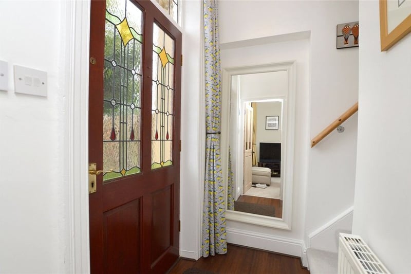 The stained glass entry door leads to the bright hallway.