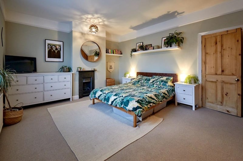 The superb master bedroom with a feature fire place, venetian blinds and fitted wardrobes.