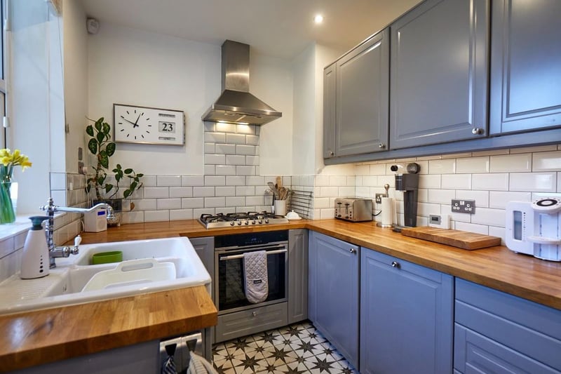 The kitchen to the rear of the house has a range of shaker style wall and base units with solid wood worktops over.