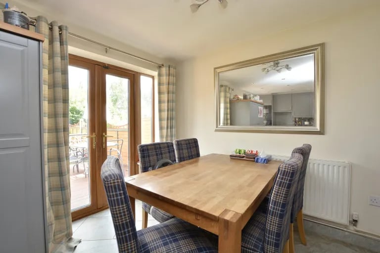 The dining area also has French doors leading to the rear garden.