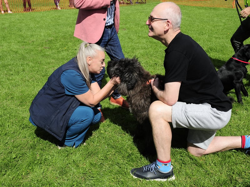Vet nurse Lotte Stamp of Ashlands Vets judging Enzo a Bouvier with owner Dan Bateman.