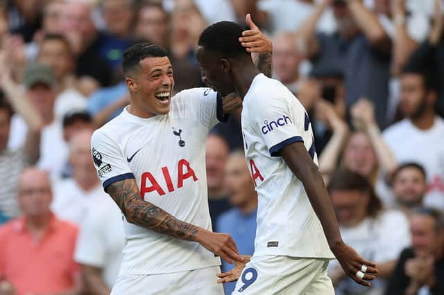 Tottenham Hotspur’s Spanish defender #23 Pedro Porro congratulates Tottenham Hotspur’s Senegalese midfielder #29 Pape Matar Sarr (Photo by ADRIAN DENNIS/AFP via Getty Images)