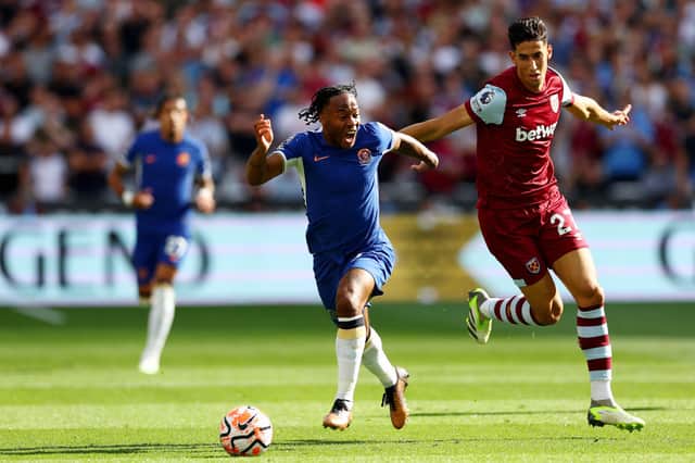  Raheem Sterling of Chelsea runs with the ball whilst under pressure from Nayef Aguerd  (Photo by Clive Rose/Getty Images)