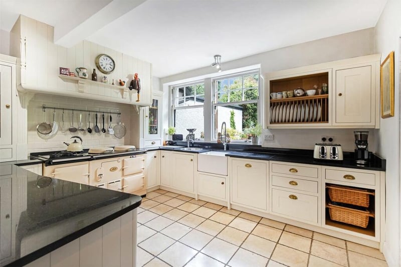  The kitchen boasts substantial storage including a butler's pantry and the breakfast room which is open-plan to the kitchen with granite breakfast bar, counter-tops, shaker-style units with in-built appliances and 4-oven dual-fuel Aga with intelligent energy management.