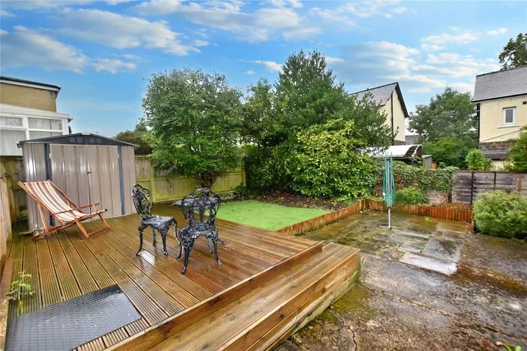 The low maintenance garden with Astro Turf and a patio seating area.