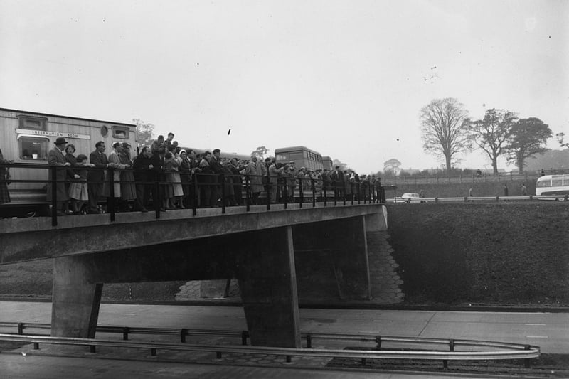  A crowd on a bridge watching the opening by Ernest Marples, British Minister of Transport, of the London to Birmingham motorway - 72 miles long and Great Britain's first motorway.  (Photo by Harry Todd/Fox Photos/Getty Images)