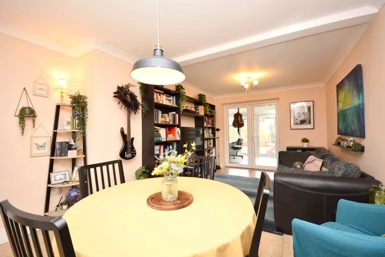 The generous dining room and living room with French doors to the garden room.