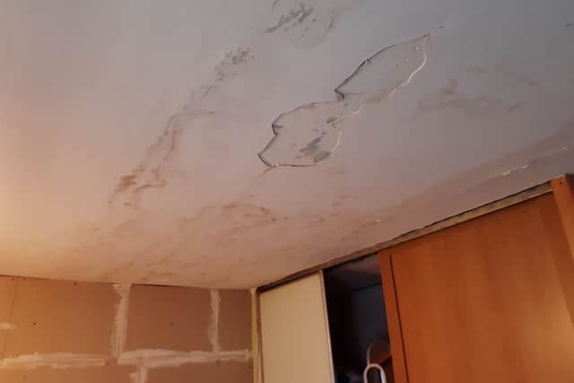 The ceiling of the couple's bedroom, now partly repaired, leaked through from the home upstairs onto their bed last year.