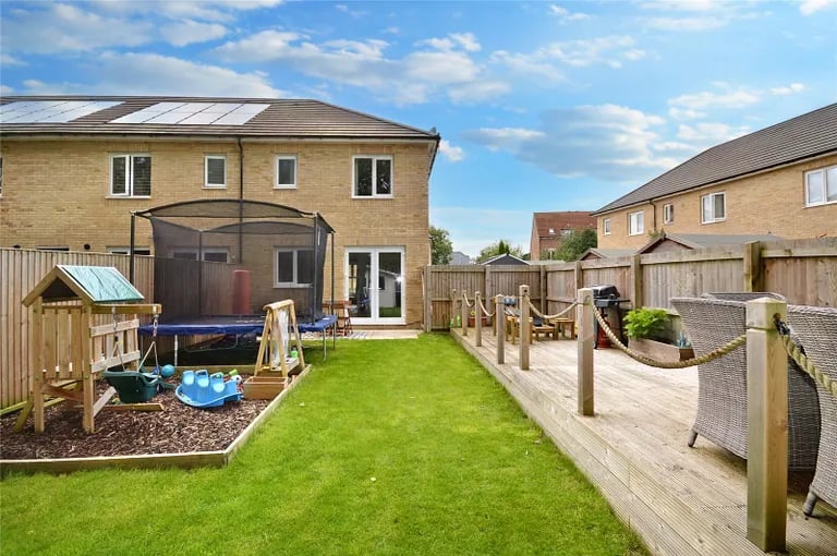 The larger-than-average rear garden with lawns and patio.