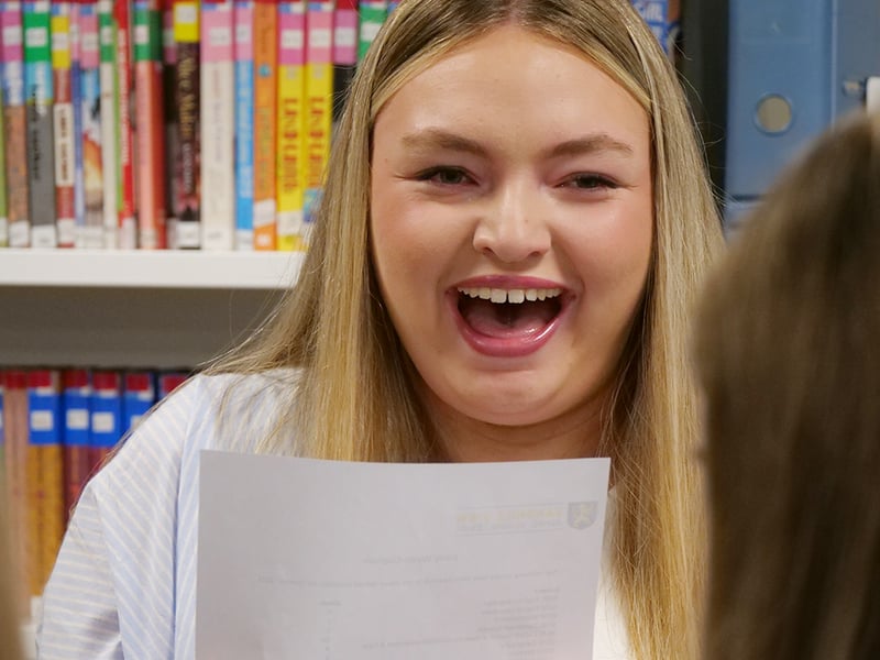 A Sandhill View Academy student shows her joy after opening her results.