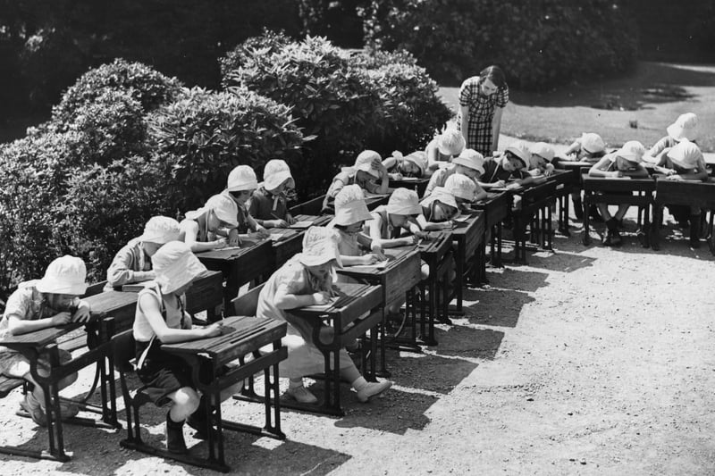 Pupils of Underlea Open Air School at Liverpool, wearing sunbonnets in the grounds.