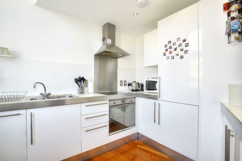 The kitchen has an integrated fridge freezer and ample storage, especially for its size.