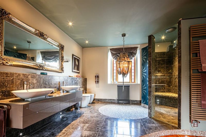 The largest bathroom, unbelievably an ensuite for the largest bedroom, has granite floors, a grand mirror, walk-in shower, and bath, giving it a rich and luxurious feel.