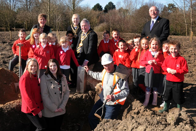 Burying a time capsule in the new development area of Barnes Park in 2011.
Taking part were all these people, including pupils from Barnes Infants school.