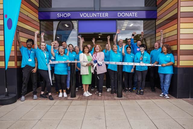 Fay Adair, left, and Sam Marsden, right, cut the ribbon with CRUK Sheffield Meadowhall's new staff