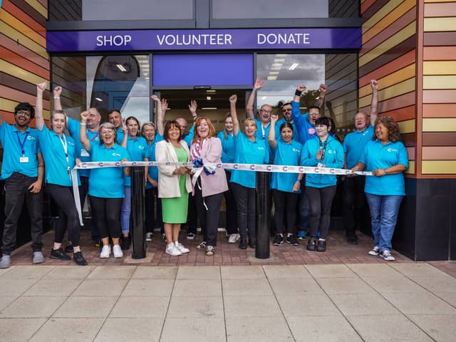 Fay Adair, left, and Sam Marsden, right, cut the ribbon with CRUK Sheffield Meadowhall's new staff