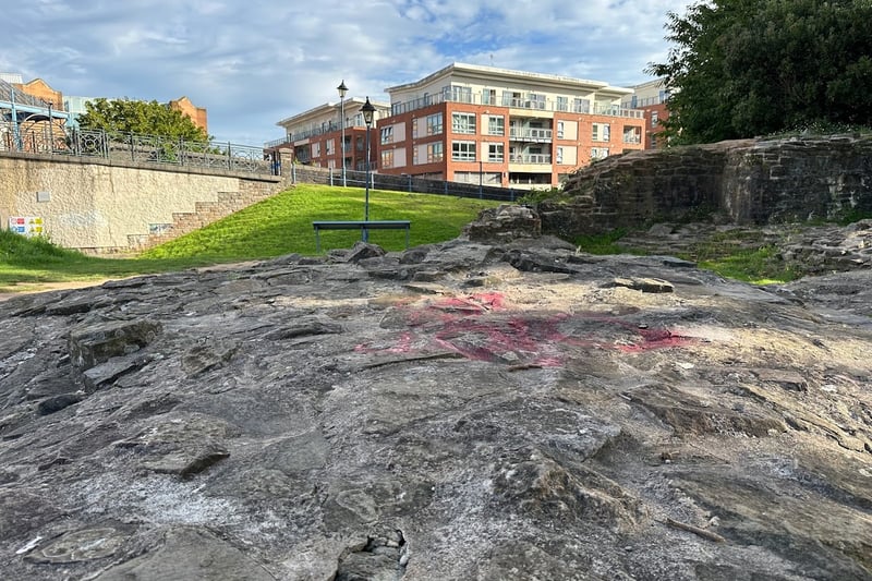 The stone foundation remains of the keep can still be seen coming out of the earth in the park. The keep walls were 25ft thick. It is believed that the keep was built in 1480. Behind it, the flats and buildings of the city centre can be seen.