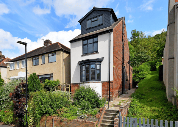 The large, detached family home is raised from the pavement level, providing natural light and beautiful views.