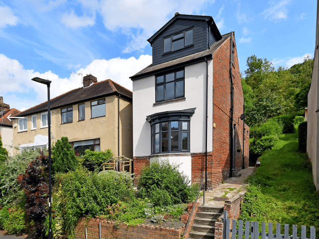 The large, detached family home is raised from the pavement level, providing natural light and beautiful views.