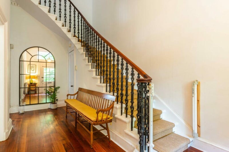 A beautiful welcoming reception hall with under stair storage. 
