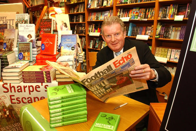 Football commentator John Motson took time to read the Football Echo on his 2004 visit to Ottakars.