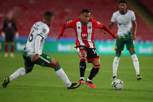 Cameron Archer of Sheffield United tussles with Ethan Erhahon of Lincoln City  during the Carabao Cup match at Bramall Lane. Simon Bellis / Sportimage