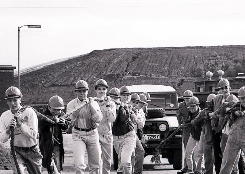 Staff from Henry Boot Limited take part in a sponsored truck pull in August 1990