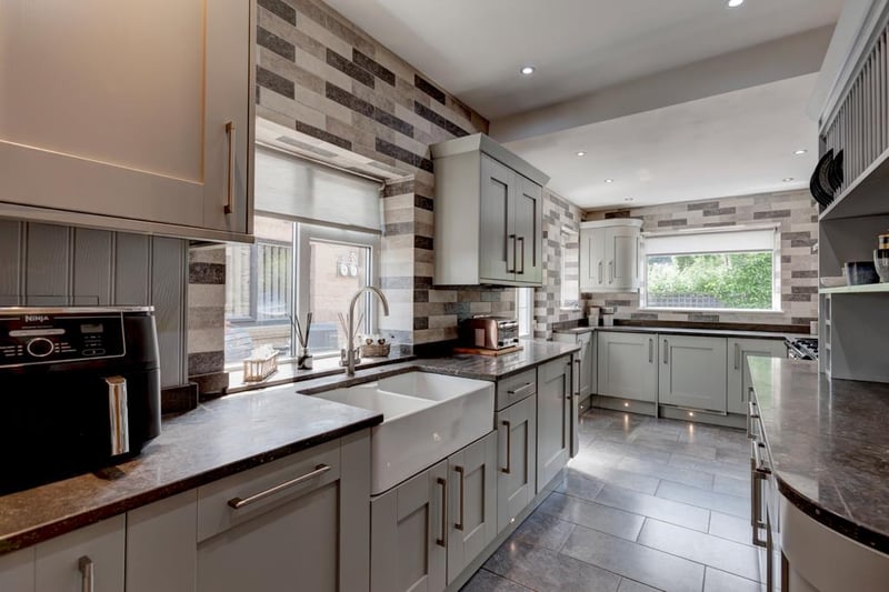The modern, sleek kitchen has fully tiled walls, a telephone point, central heating radiator and tiled flooring. Appliances include a Rangemaster range cooker, integrated fridge and freezer, dishwasher and washing machine.