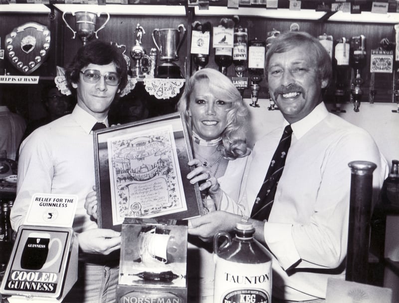 Mike Hensman, left, chairman of Sheffield CAMRA, making the presentation of the Pub of the Year trophy to Ray and Chris Finlay, of Shakespeare's, on Gibraltar Street, Sheffield, in July 1983