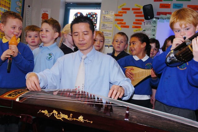 Jiang Li was helping pupils at Bournmoor Primary School with the skills of Chinese  guitar playing 15 years ago.
