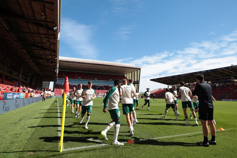 Hibs players warm up at Pittodrie ahead of facing Aberdeen. 
