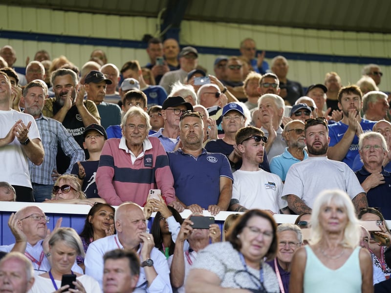 Some fans look at the camera, whilst others look on at the action on the pitch