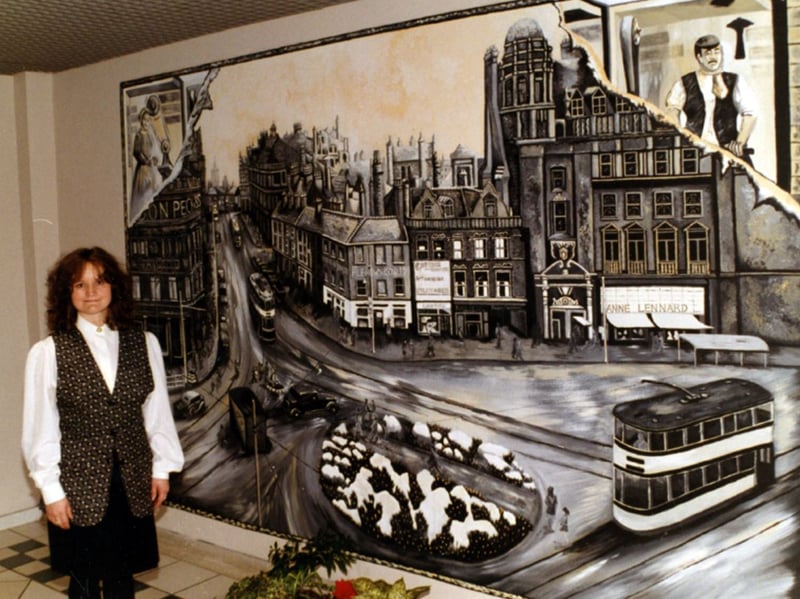 Angela Crenshaw with her mural on the top floor of Orchard Square, Sheffield city centre, in 1995. The mural depicts the Orchard Square area before the shopping centre was built. Photo: Picture Sheffield/Sheffield Newspapers