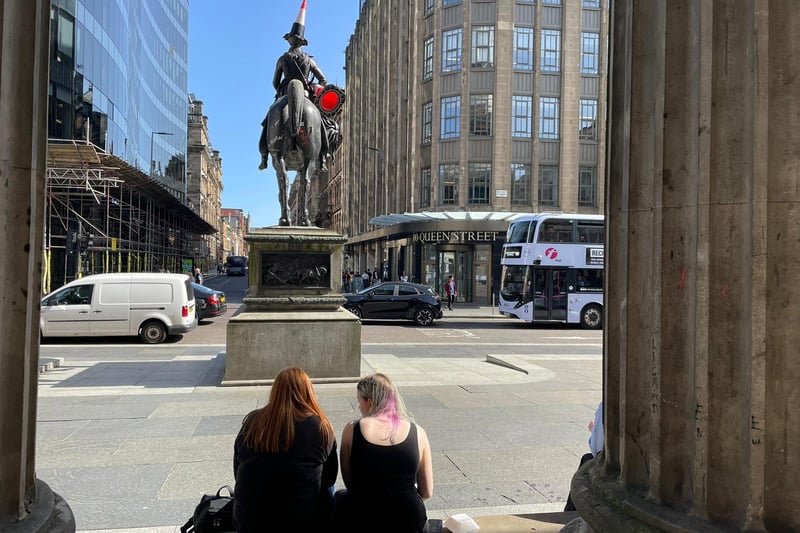 Some pals meet up for lunch on the GOMA steps - the Duke of Wellington hangs onto a spare cone in case his hat falls off