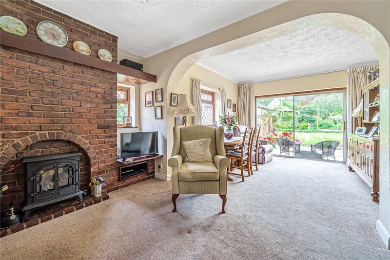 It has a gas coal effect burning stove set in a brick surround fireplace.