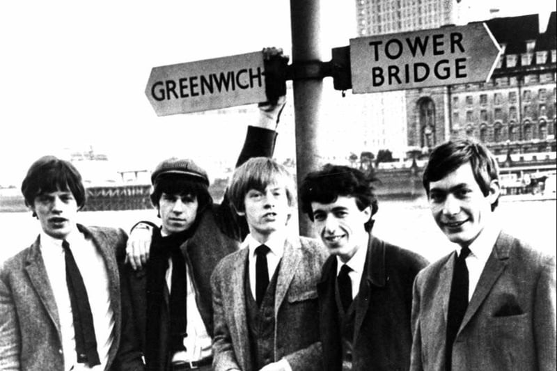The Rolling Stones beneath a sign for Greenwich and Tower Bridge in around 1963. L-R: Mick Jagger, Keith Richards, Brian Jones, Bill Wyman and Charlie Watts. (Photo by Hulton Archive/Getty Images) 
