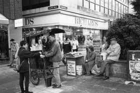 Newspaper and chestnut sellers outside Richards, at the junction of Fargate and Chapel Walk, Sheffield, in November 1992. Photo: Picture Sheffield