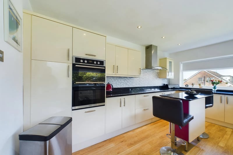 The modern kitchen with sleek cabinetry and a range of integral appliances.