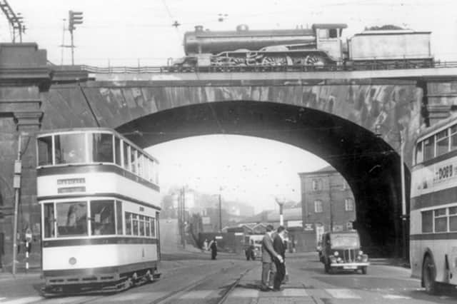 Sheffield's famous Wicker Arches, with a train travelling overhead and a tram to Darnall passing underneath. The railway bridge and adjoining viaduct and buildings, dating back to 1848, are Grade II*-listed. They are described as an 'outstanding example of monumental early railway architecture'. Photo: Picture Sheffield