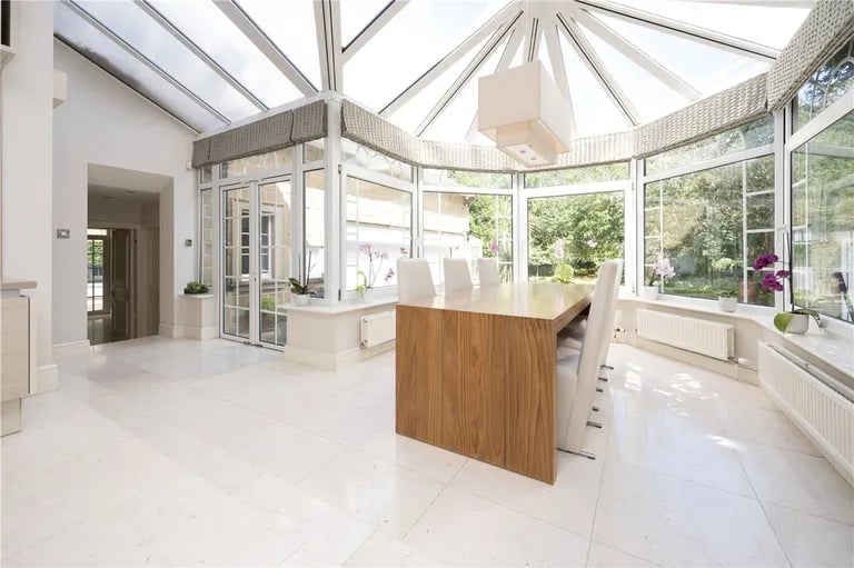 The stunning dining area with large surrounding windows.